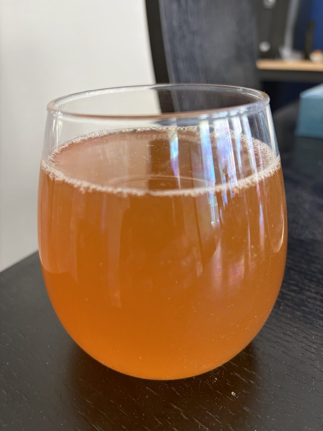Orange-colored sample of the Hoegaarden-style homebrew tasted before keg conditioning