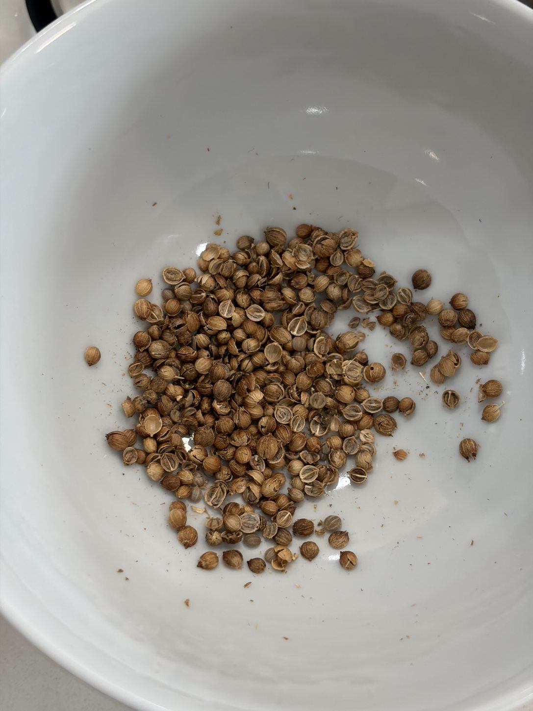 Lightly crushed coriander with broken seed husks