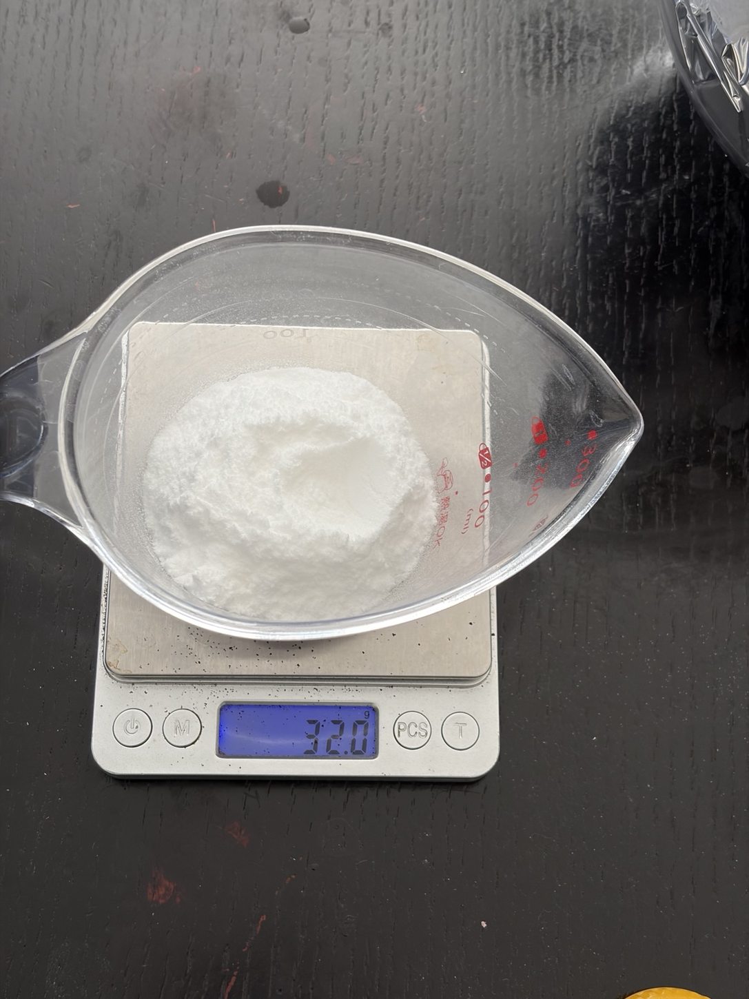 Digital scale reading 32.0 g of dextrose